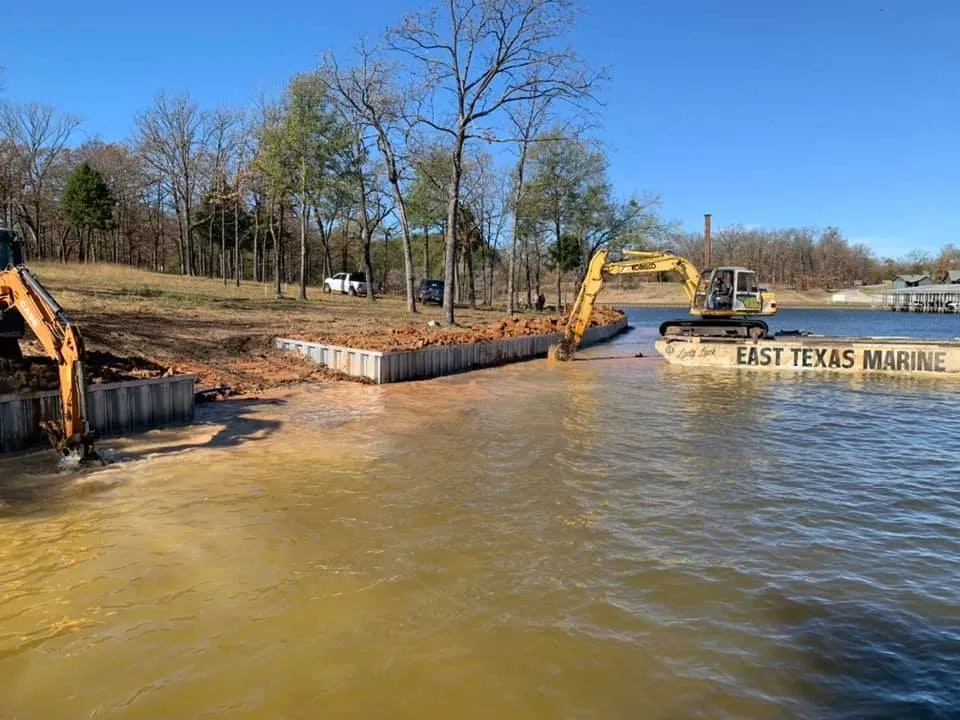 download (8) Pictured construction of a deck in progress with heavy equipment