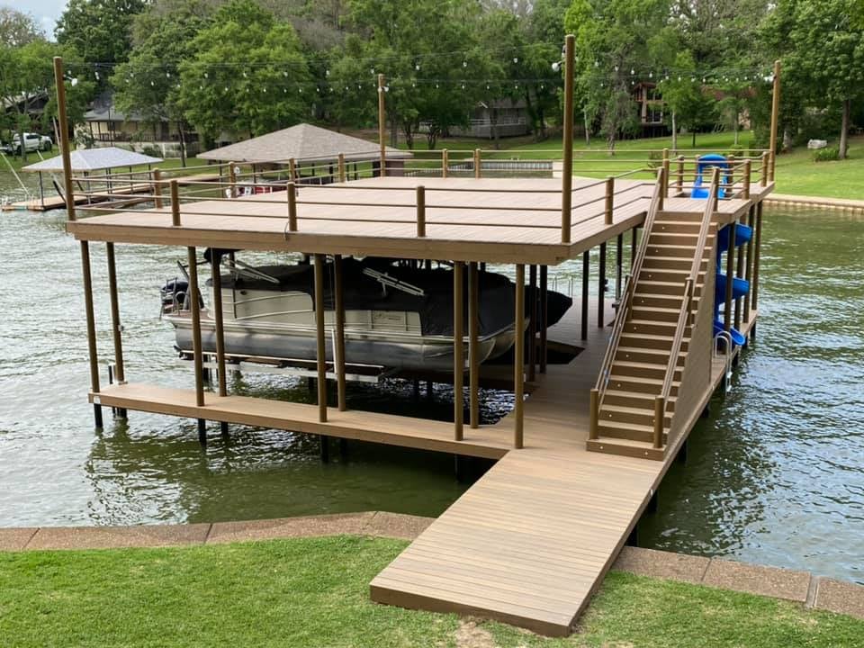 274333244_467899578200504_2536567044866712484_n (1) Custom Double Dock on the water with a slide, stairs and accent lighting and flood lights