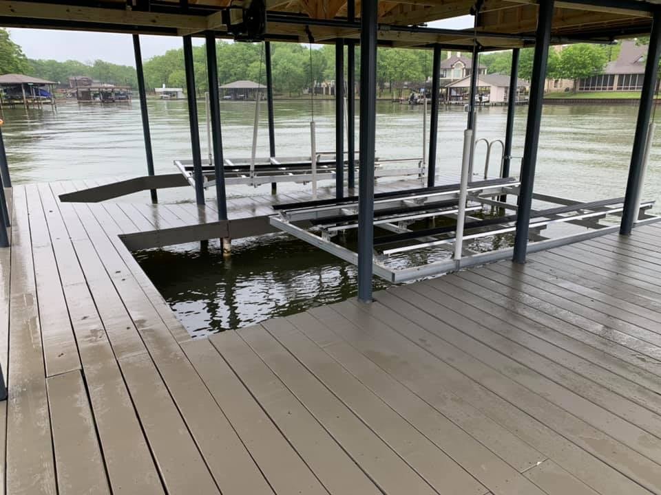 275008885_467756461548149_7610149927014798492_n Two boat holders in a custom deck / covered boat house on the water