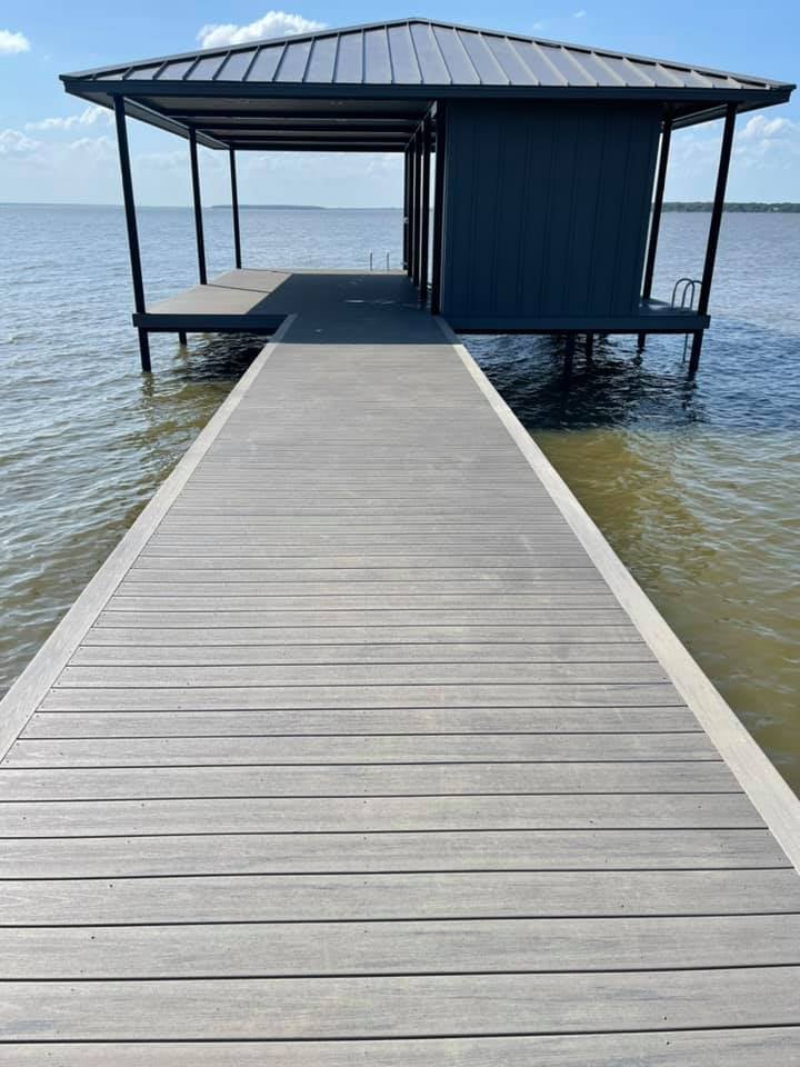 275012991_467731641550631_1899088887611600153_n Walkway of a deck leading to a covered boat house with stairs that go down into the water