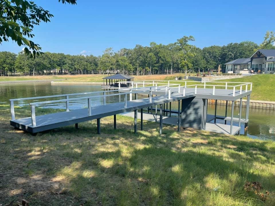 275043039_467719628218499_4889659196692040634_n Long dock starting from land going to the water in gray color