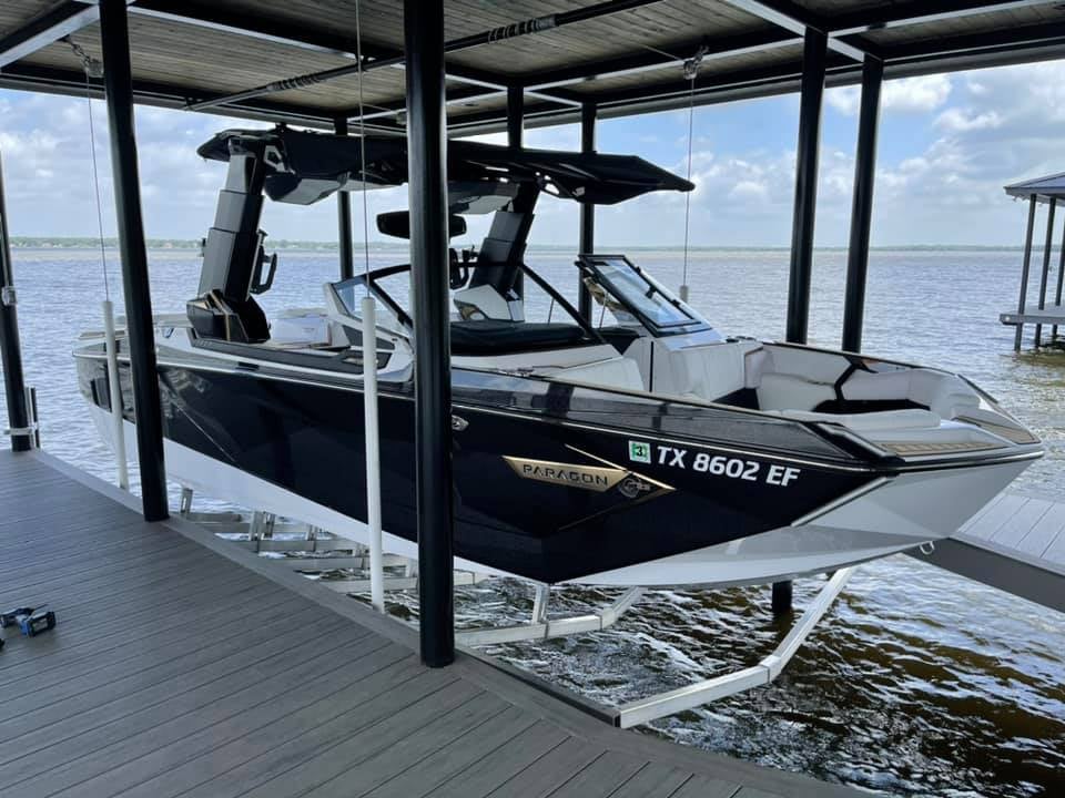275052724_467731648217297_7163433979396788524_n A Paragon sports boat pictured on a boat stand in a boat house/deck