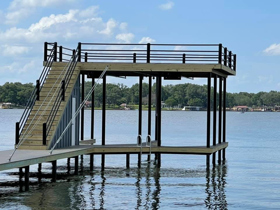 275071301_467720128218449_2070701701410139435_n Side angle of a deck pictured on the water with stairs leading to a top level deck, and down into the water