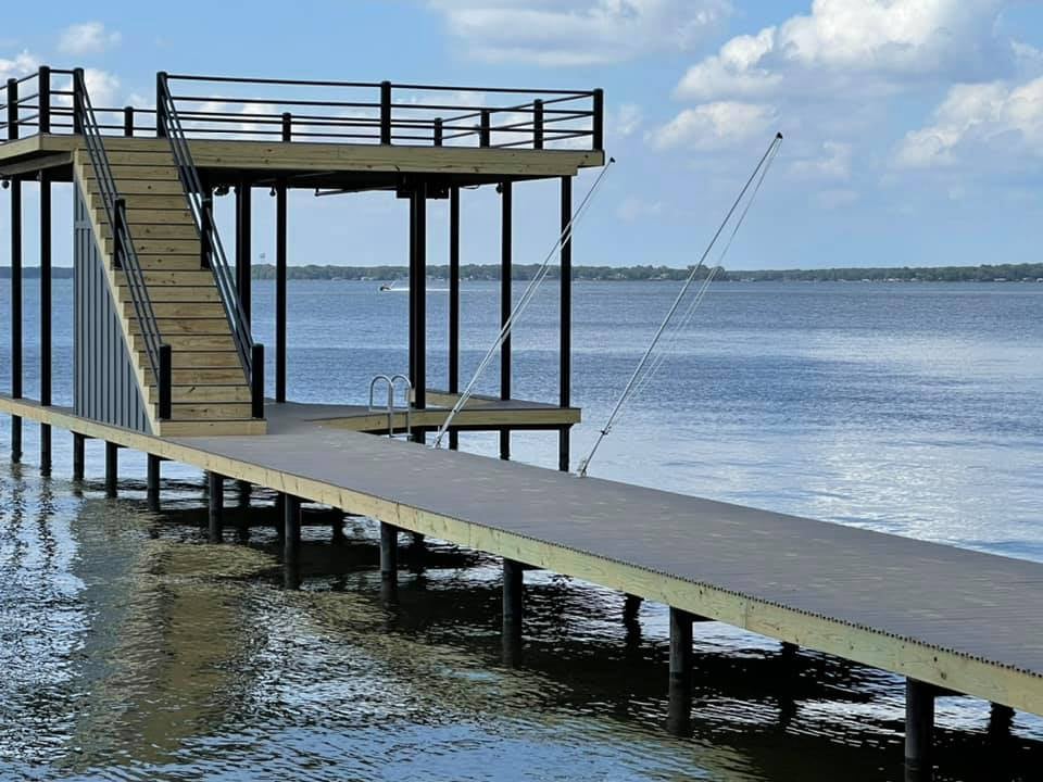 275076445_467720141551781_1087199610252379562_n Deck pictured on the water with stairs leading to a top level deck, and down into the water
