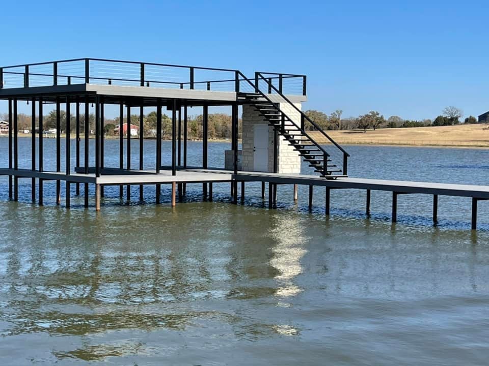 275119122_467709114886217_4818315829015167629_n Custom double layered deck with stairs pictured on the water